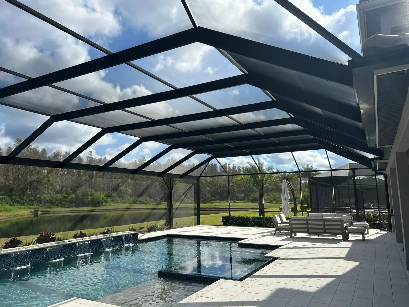 Lily Luxe Rescreen pool cage restoration surrounding a Florida pool and patio.